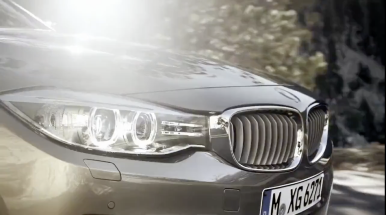 Sideshot of a BMW driving in the sun